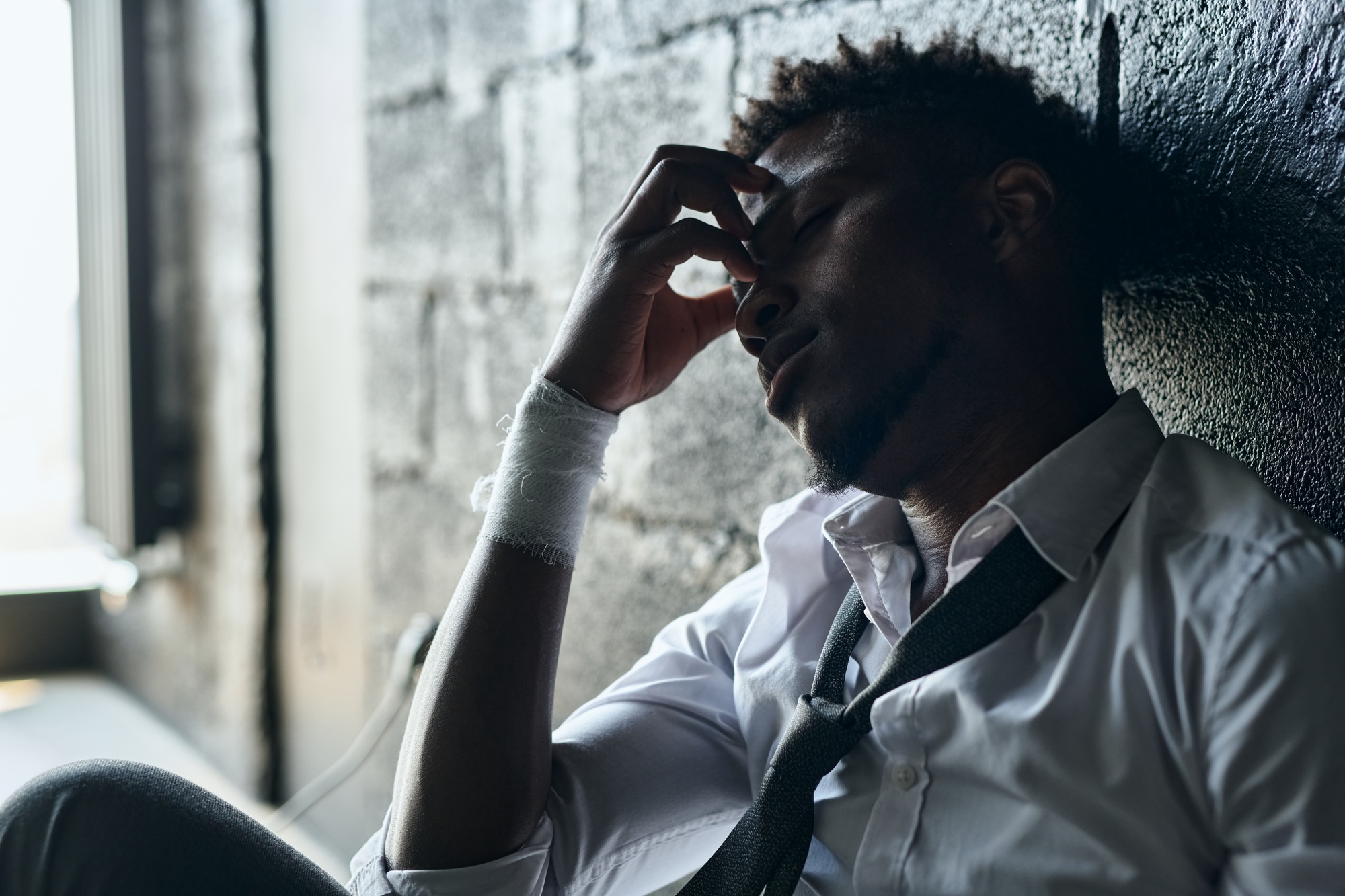 Man with bandaged wrists having depression
